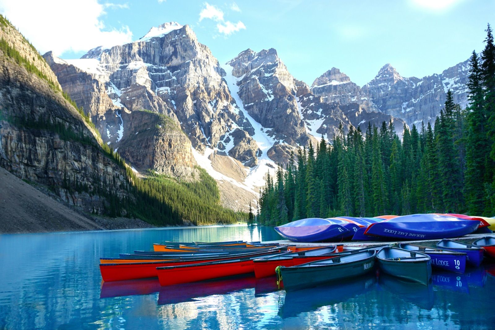Canoe on azure Moraine Lake beneath the snow-dusted Ten Peaks — Banff Journey Lake Louise & Moraine Lake tour
