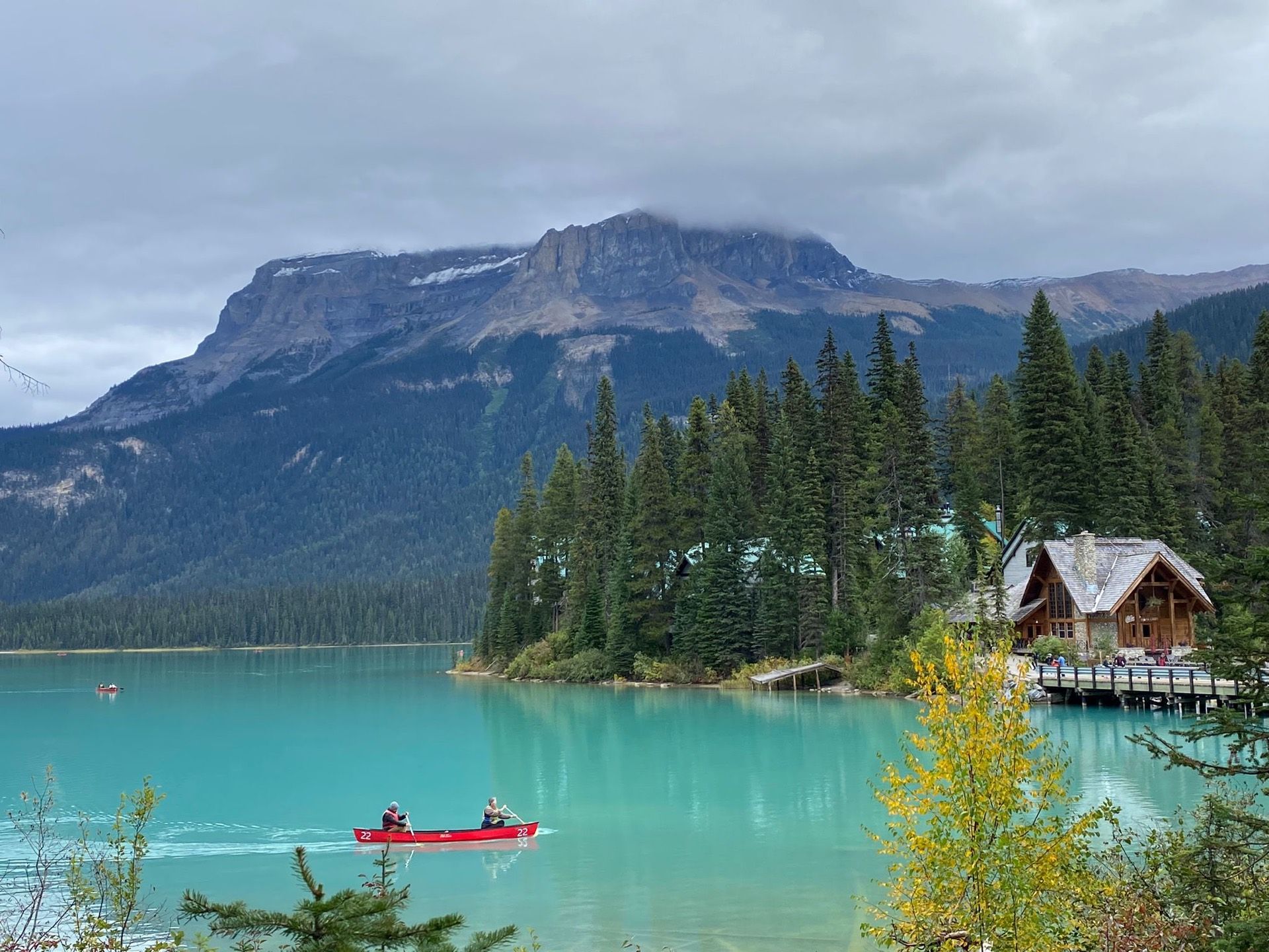 A canoe on turquoise Emerald Lake below a Rocky Mountain peak, Yoho National Park — Banff Journey contact